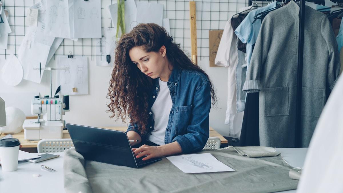 Une freelance travaille sur son ordinateur dans son atelier